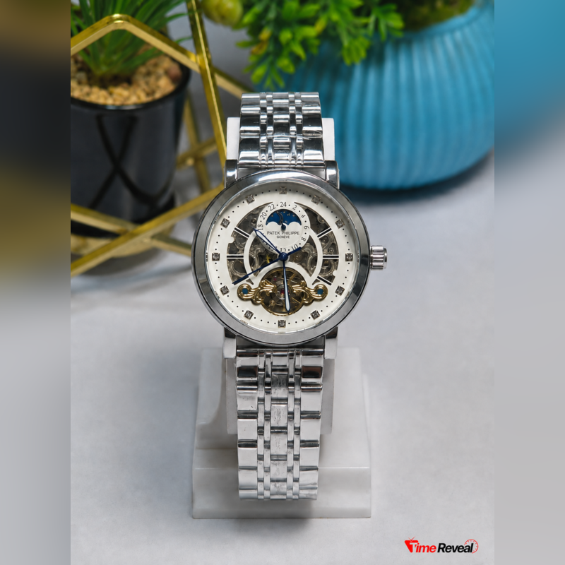 Silver Patek Philippe open heart style watch held by hand