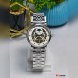 Silver Patek Philippe open heart style watch held by hand