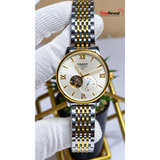 TISSOT automatic skeleton watch gold and silver men's wrist view